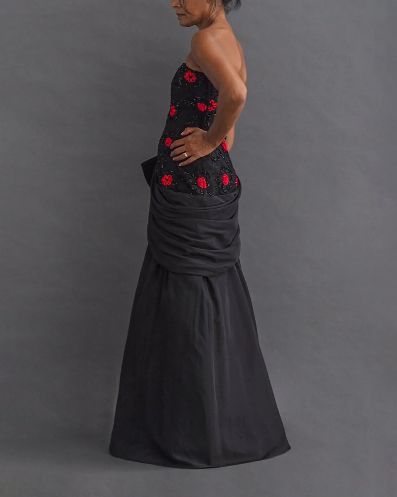 TERENCE NOLDER LONDON - asymmetrical strapless gown Strapless black taffeta gown with metallic thread and red ribbon embroidery plus giant 80's bow attaching an asymmetrical sash.