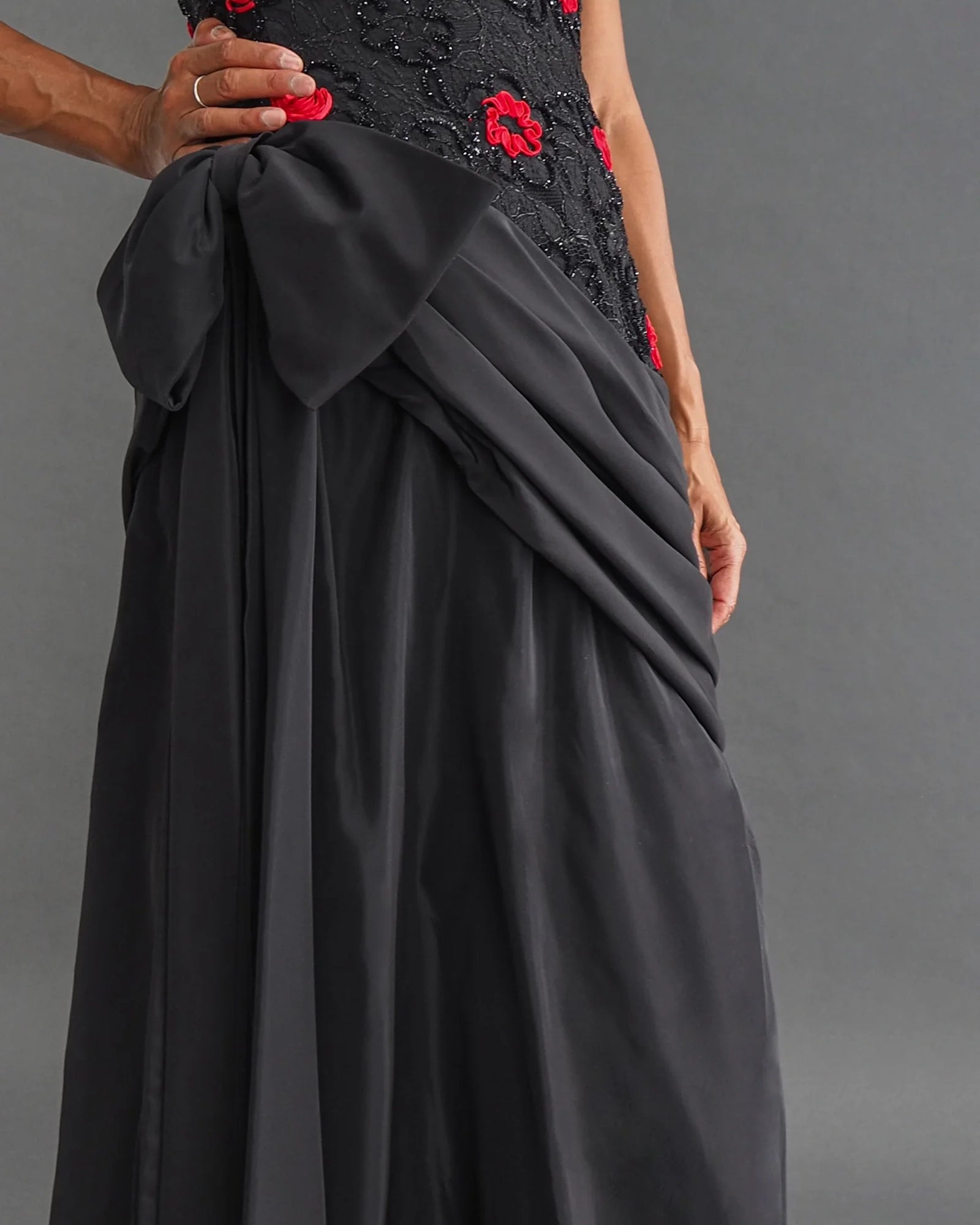TERENCE NOLDER LONDON - asymmetrical strapless gown Strapless black taffeta gown with metallic thread and red ribbon embroidery plus giant 80's bow attaching an asymmetrical sash.