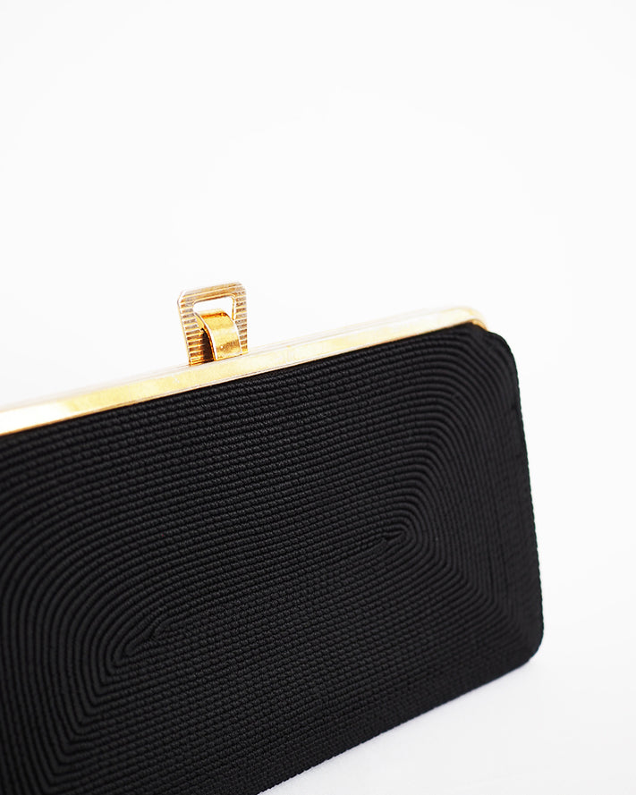 Vintage black corde envelope clutch featuring abstract tone on tone pattern.