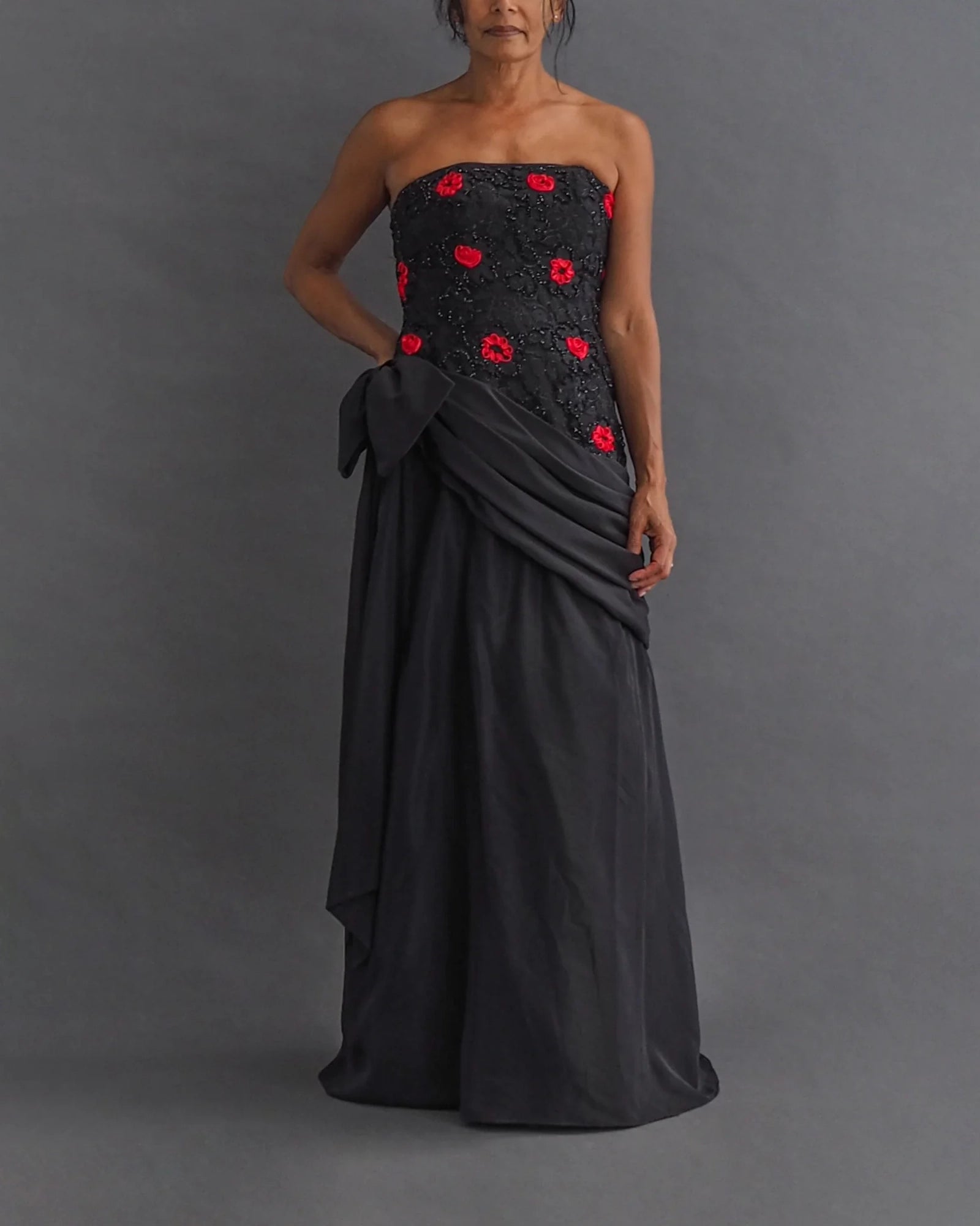 TERENCE NOLDER LONDON - asymmetrical strapless gown Strapless black taffeta gown with metallic thread and red ribbon embroidery plus giant 80's bow attaching an asymmetrical sash.