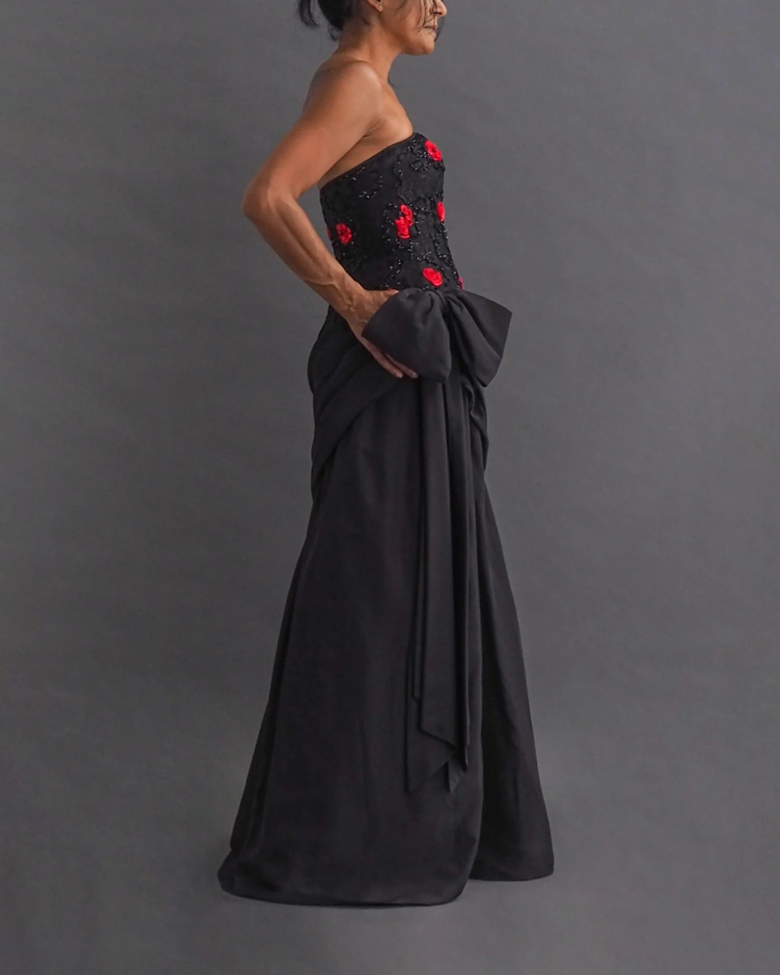 TERENCE NOLDER LONDON - asymmetrical strapless gown Strapless black taffeta gown with metallic thread and red ribbon embroidery plus giant 80's bow attaching an asymmetrical sash.