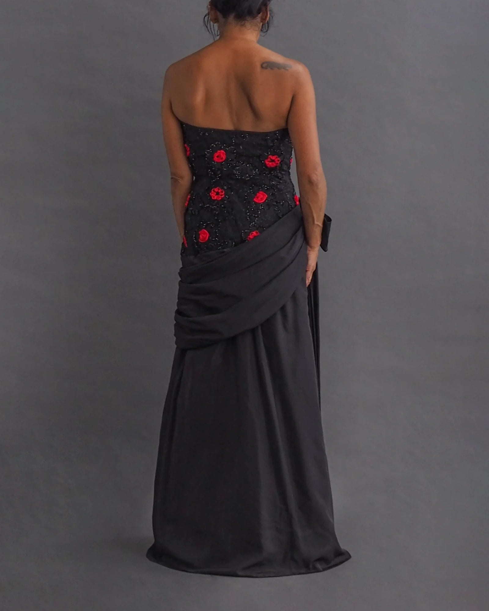 TERENCE NOLDER LONDON - asymmetrical strapless gown Strapless black taffeta gown with metallic thread and red ribbon embroidery plus giant 80's bow attaching an asymmetrical sash.