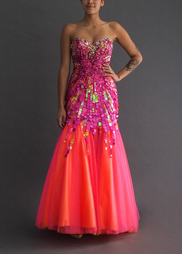 Neon Alyce Paris mermaid style gown with layers of luminescent orange and fuchsia tulle sprouting from a drop-bodice heavy in holographic sequins.