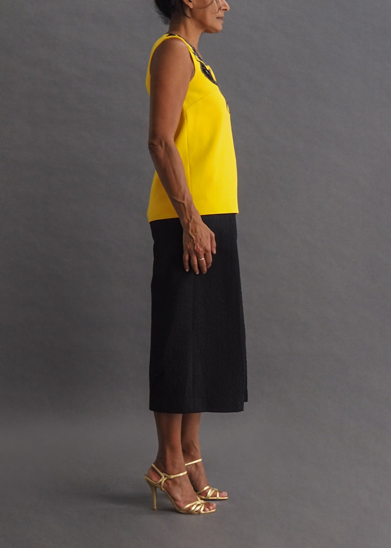 CHRISTOPHER KANE - TOP Sunshine yellow, sleeveless top with black and silver faux leather embellishment around the neck.
