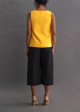 CHRISTOPHER KANE - TOP Sunshine yellow, sleeveless top with black and silver faux leather embellishment around the neck.
