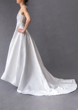 DEMETRIOS BRIDAL GOWN Pristine white heavy beaded bodice, full skirted bridal gown with train and button closure.