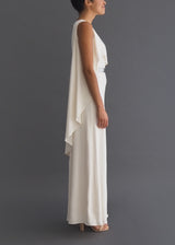 Halston sleek column bridal gown with asymmetrical cape and removable metal belt.