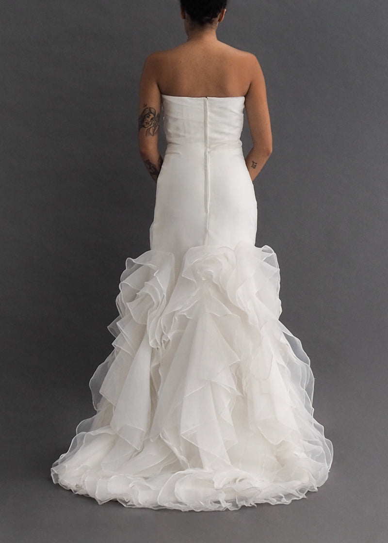 JAI INTERNATIONAL - drop waist bridal gown Simple, strapless, mermaid style gown with tiered ruffled skirting.