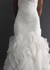 JAI INTERNATIONAL - drop waist bridal gown Simple, strapless, mermaid style gown with tiered ruffled skirting.