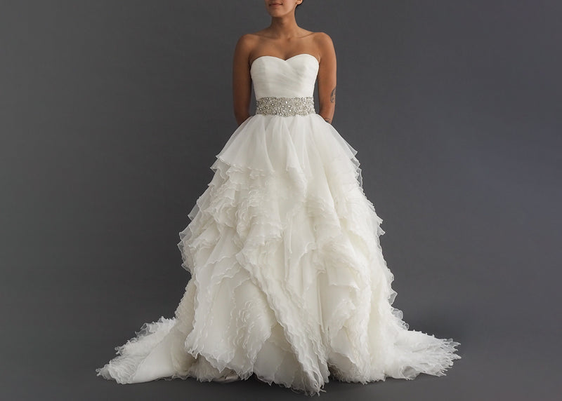 Justin Alexander wedding gown with strapless sweetheart pleated bodice, crystal encrusted waist detail, separating layers of ruffled skirt including generous button lined train.