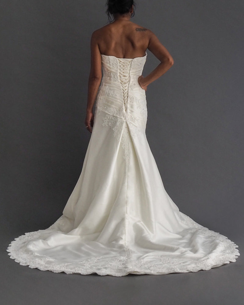 MOIRA LEE STRAPLESS BRIDAL GOWN Strapless ivory A-line gown with lace and beaded applique and dramatic train.