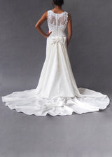 MON CHÉRI - Column bridal gown Off-white column style bridal gown with lace covered bodice, kick-pleat detail and button concealed zipper closure.