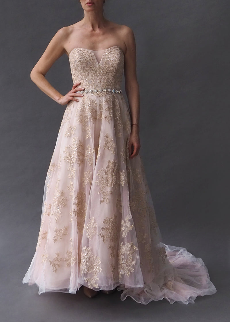 OLEG CASSINI - Blush bridal gown Strapless blush gown with tulle and metallic threaded lace overlay and delicate rhinestone belt.