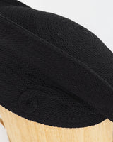 Renata Crowe , milliner to the brave- black woven textile, beret-style hat.