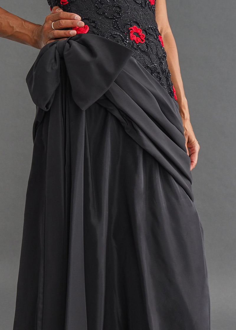 TERENCE NOLDER LONDON - asymmetrical strapless gown Strapless black taffeta gown with metallic thread and red ribbon embroidery plus giant 80's bow attaching an asymmetrical sash.