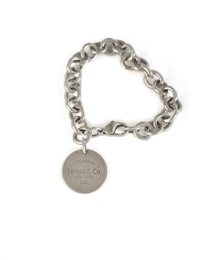 TIFFANY ROUND TAG BRACELET Return to Tiffany - stamped sterling silver heavy linked chain and lobster clasp with round signature tag. All in sterling silver.