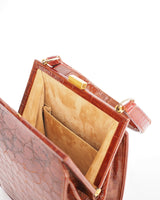 Vintage embossed, rust coloured, alligator purse with single top handle and neat rectangular shape