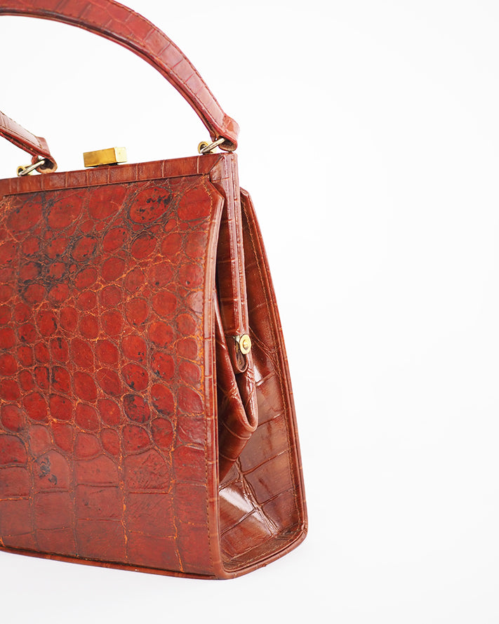 Vintage embossed, rust coloured, alligator purse with single top handle and neat rectangular shape