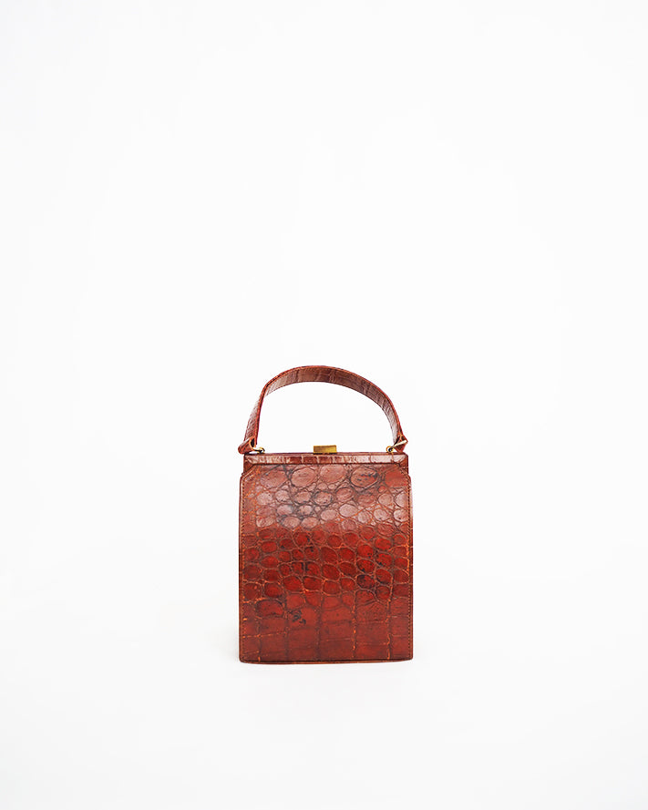 Vintage embossed, rust coloured, alligator purse with single top handle and neat rectangular shape