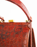 Vintage embossed, rust coloured, alligator purse with single top handle and neat rectangular shape