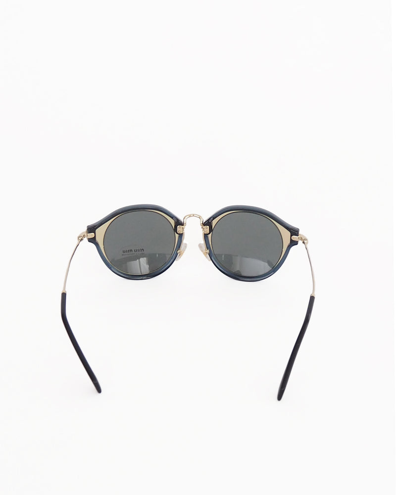 MIU MIU SUNGLASSES Style 51SS - black and transparent smokey blue frame with grey UV protected lenses.