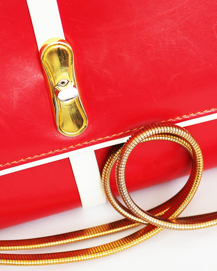 High Art vintage red leather with white piping convertible clutch/shoulder bag including retro metal elastic shoulder strap that neatly tucks away. 